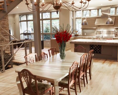 Dining room with wood table, contemporary chandelier and white trim.