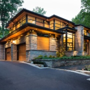 Natural modern house with wood siding and flat roof.